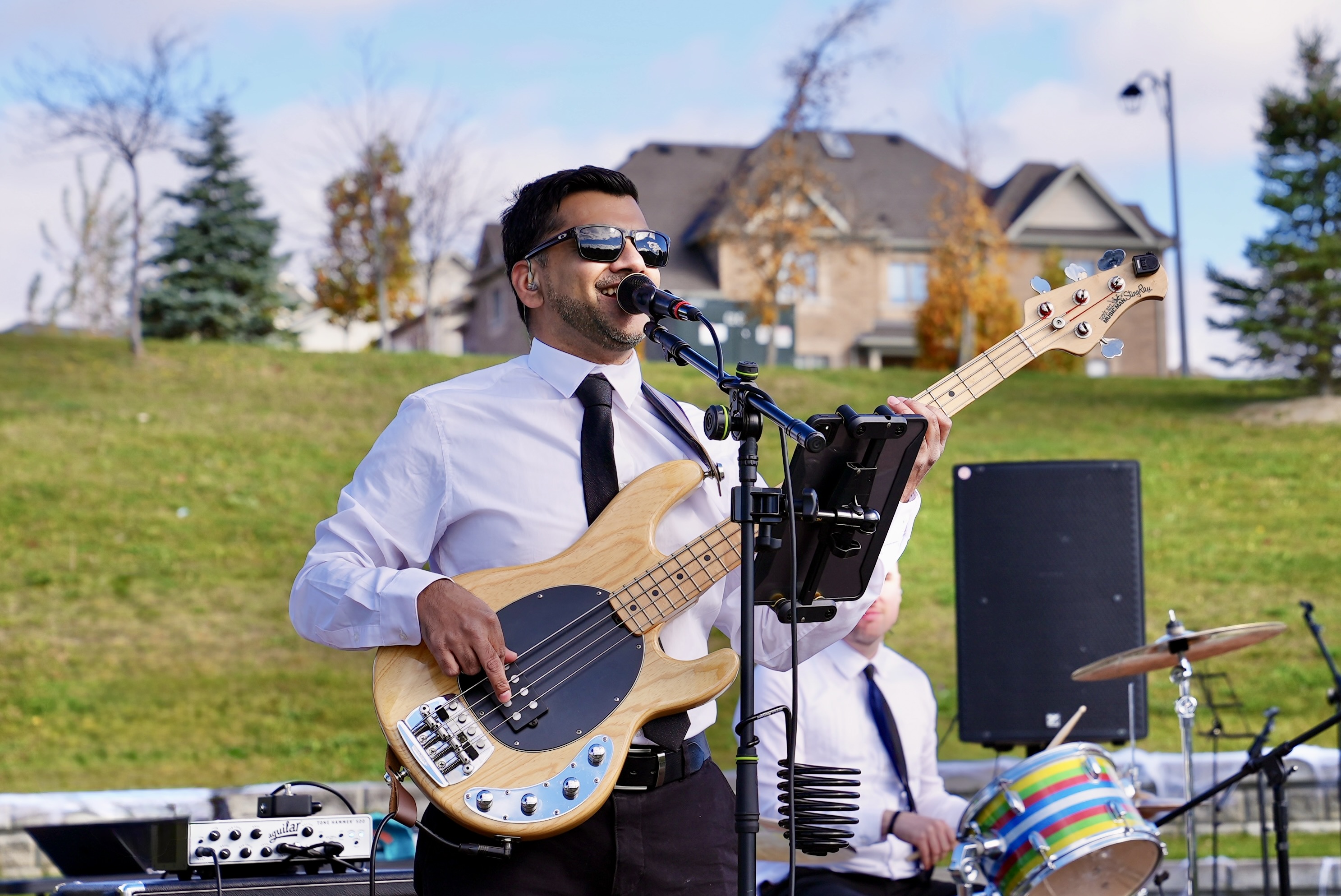 Ken on bass and vocals at outdoor festival performance